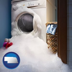 a washing machine with overflowing soap suds in a laundry - with Nebraska icon